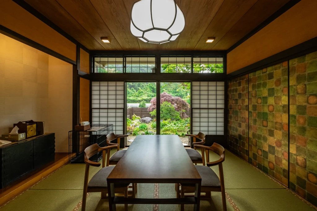 A charming traditional Japanese room overlooking verdant mountain views